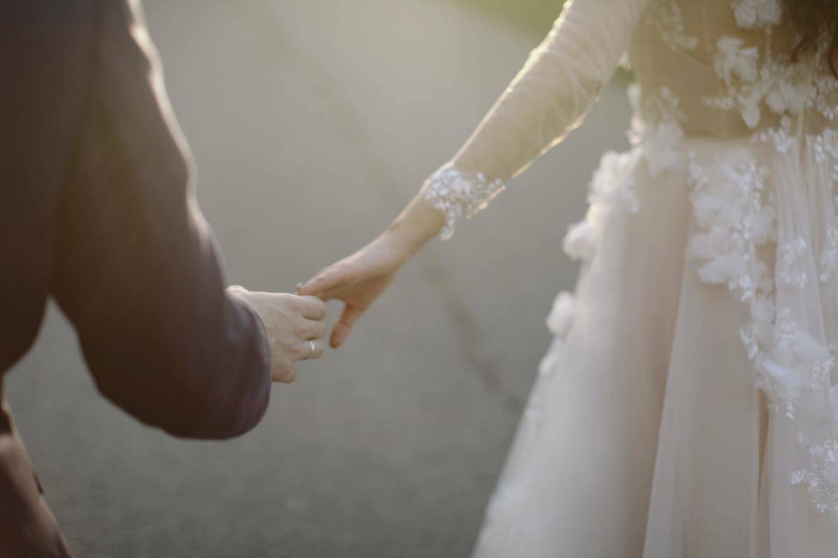 bride and groom walking holding hands