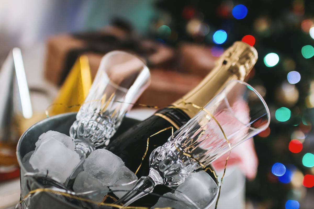 champagne bottle and glasses in ice bucket