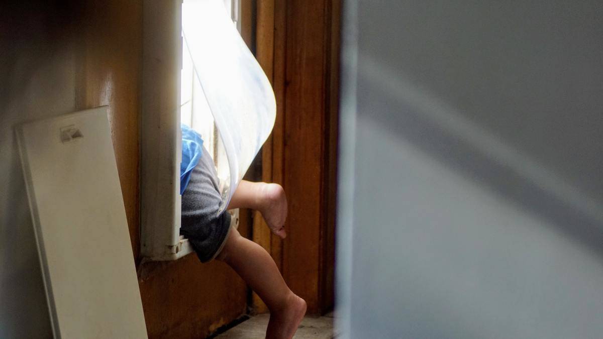 child climbing through window