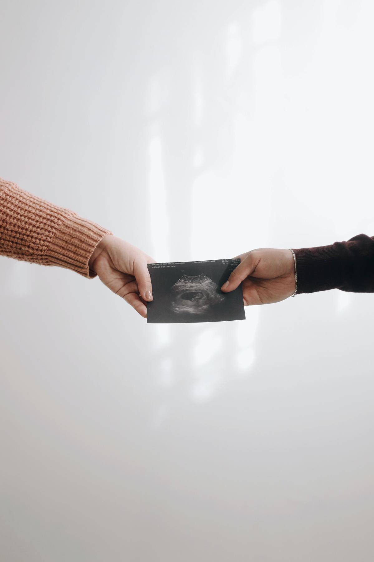 two hands holding ultrasound