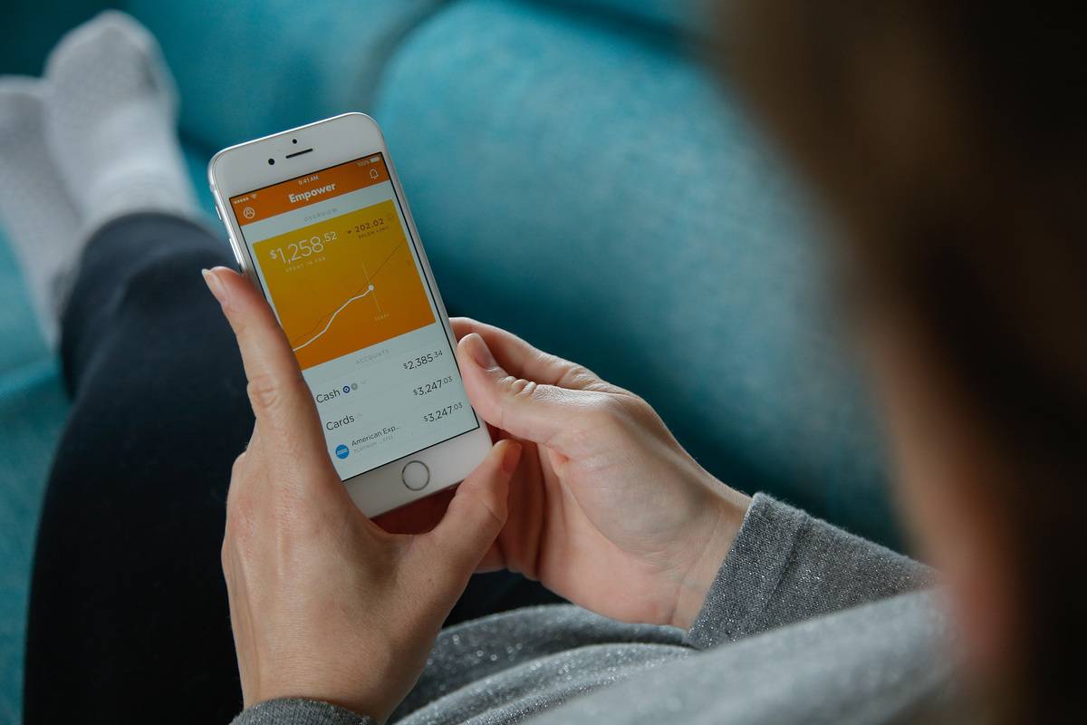 A woman sees her finances rise on the Empower app.