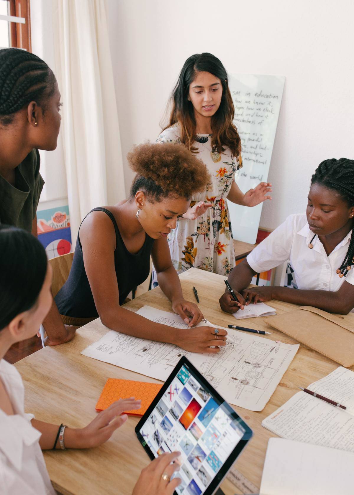 people working together at board table
