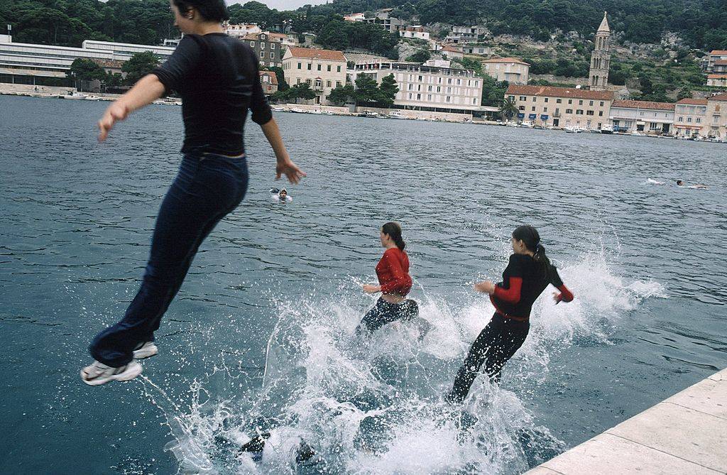 people jumping into the water in Hvar, Croatia