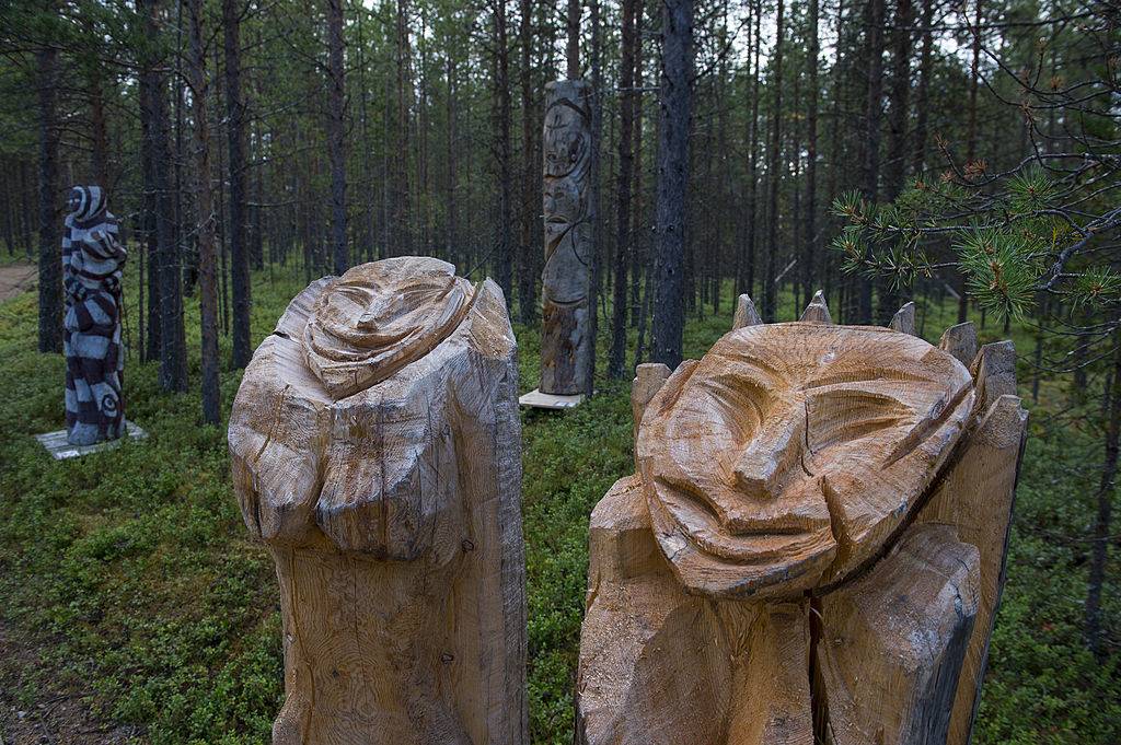 Wooden sculptures displayed outdoors at the Siida Museum in Lapland, Finland