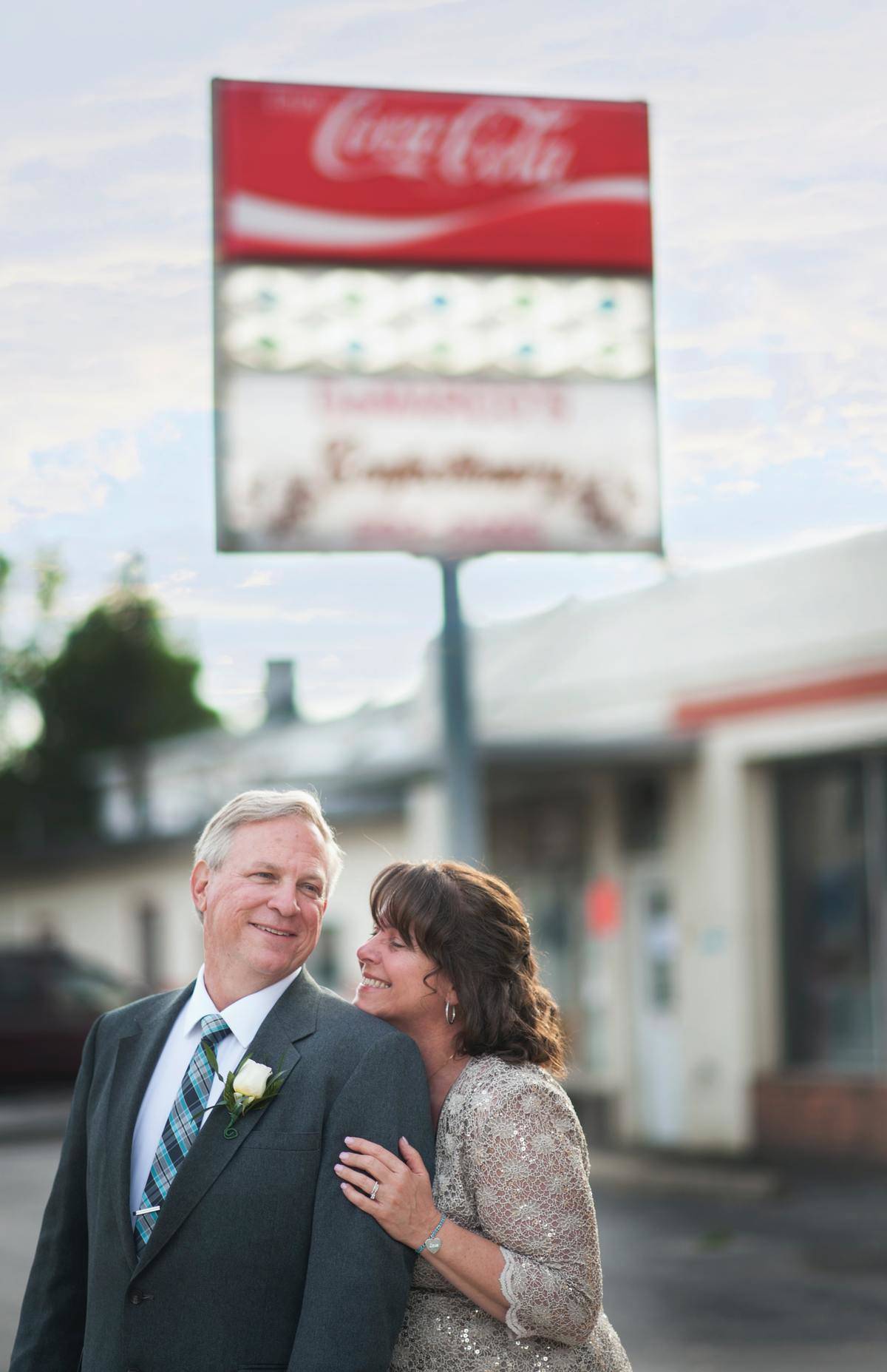 mother of the groom hugging father