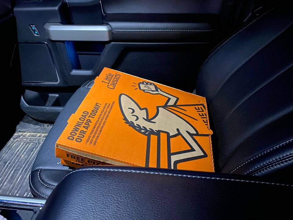 pizza box on top of a car seat