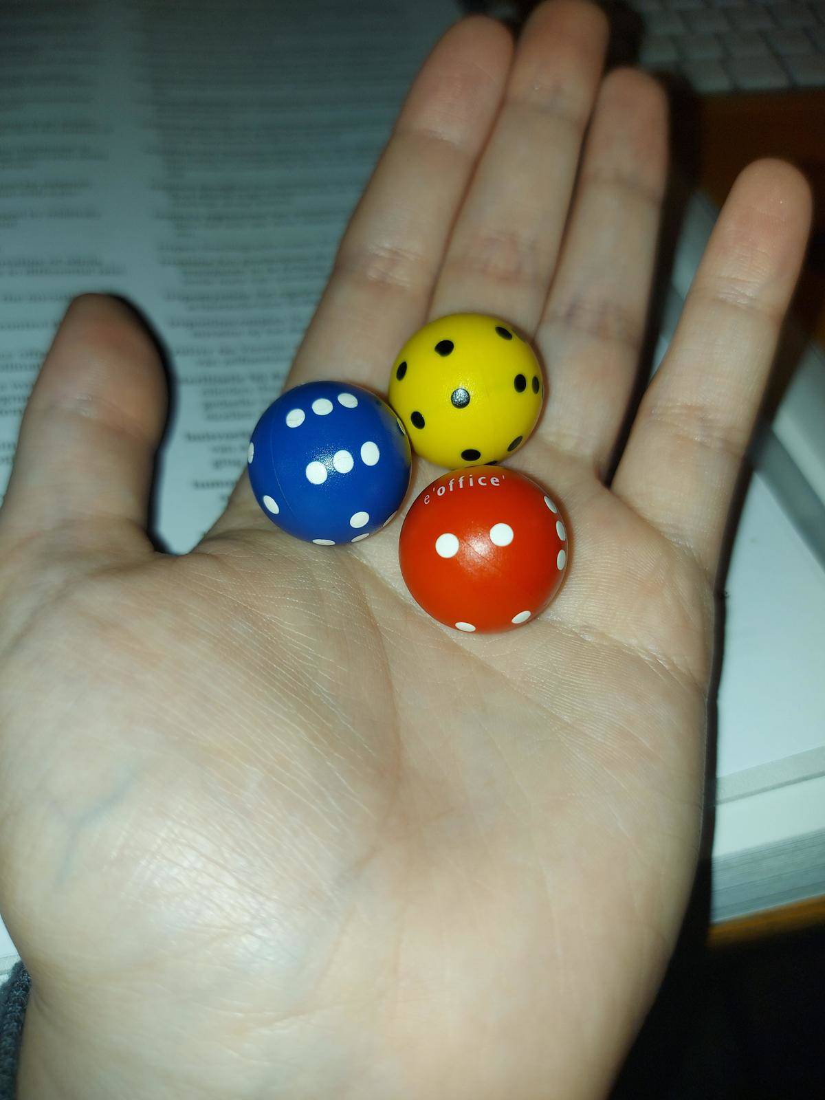 three round dice (red, yellow, and blue)