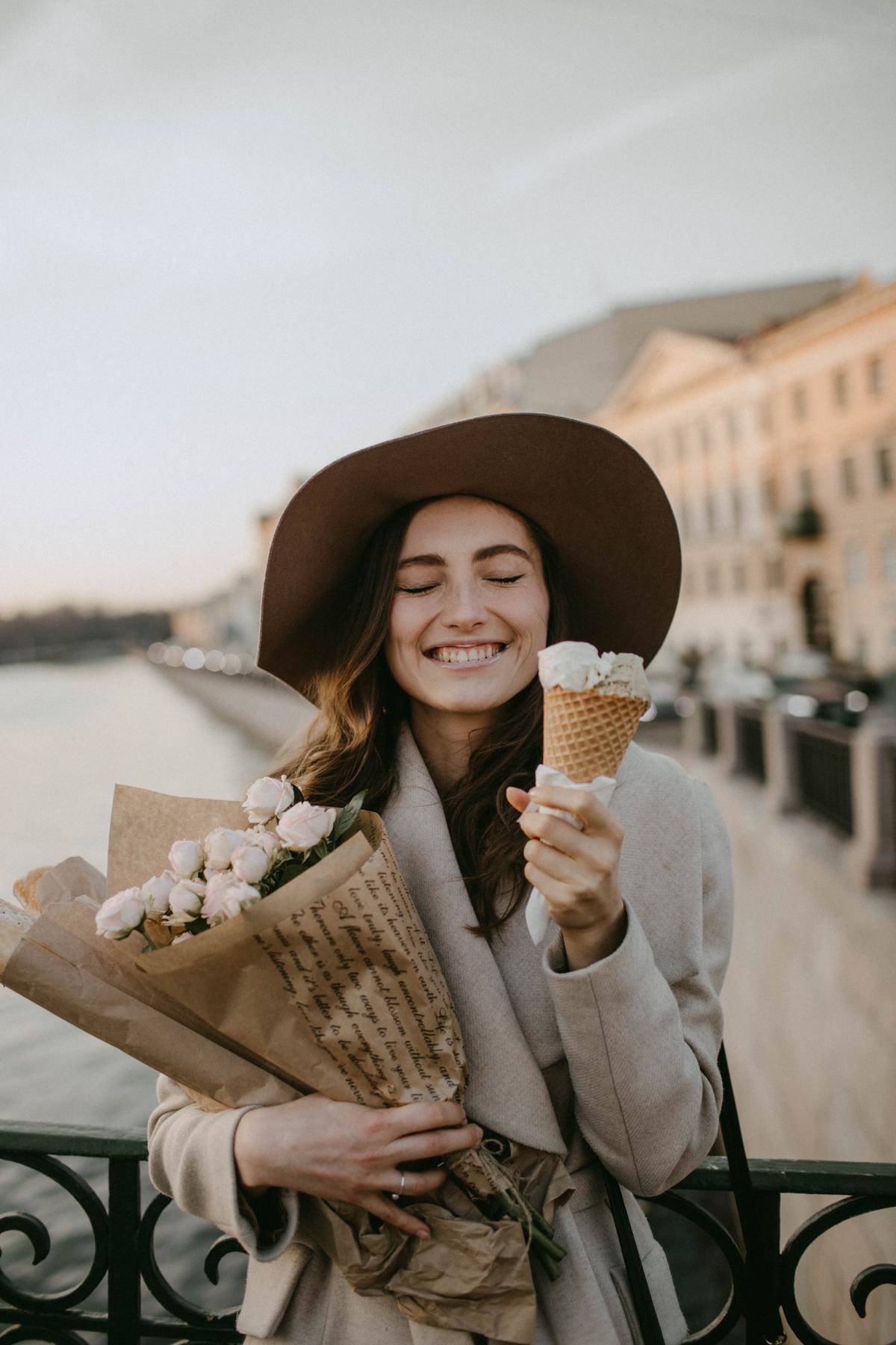 woman holding ice cream and flowers