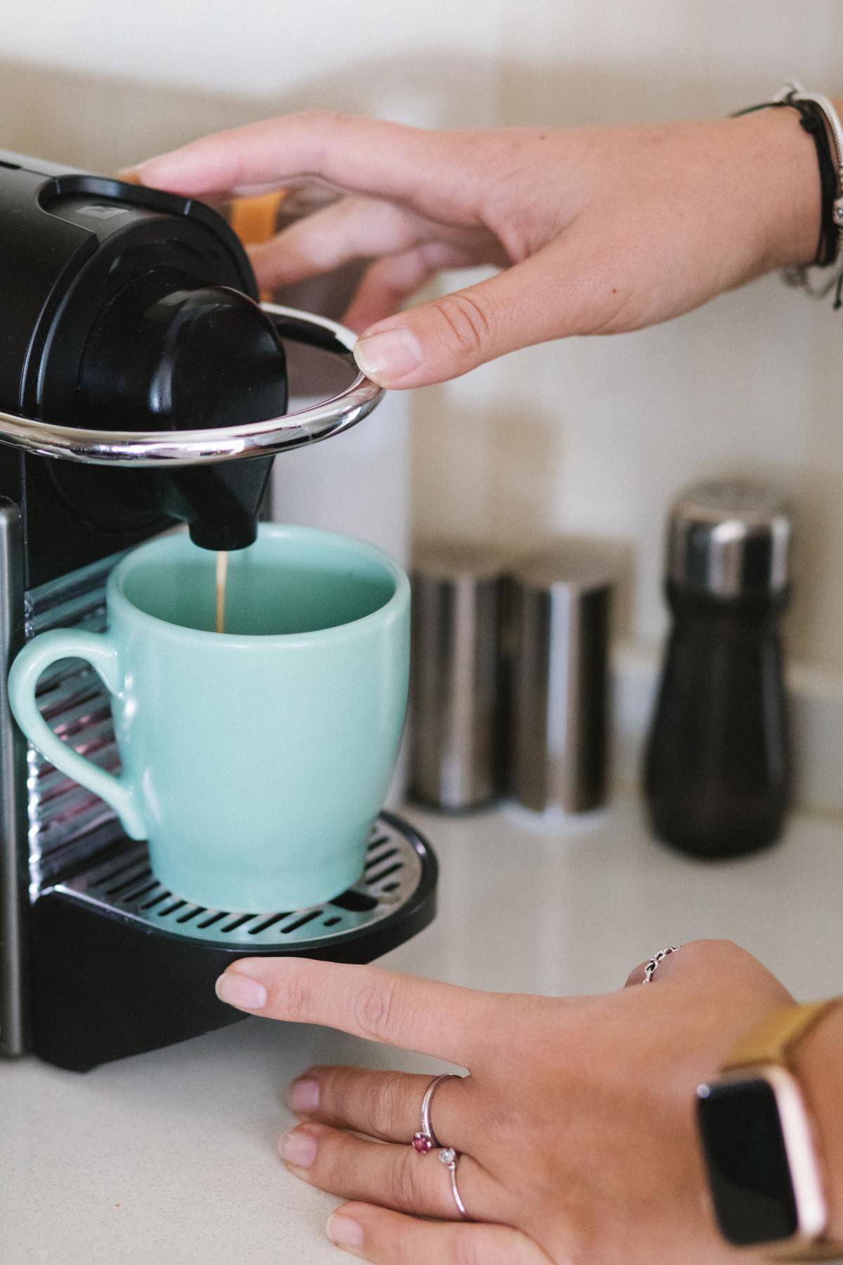 woman making coffee in blue mug