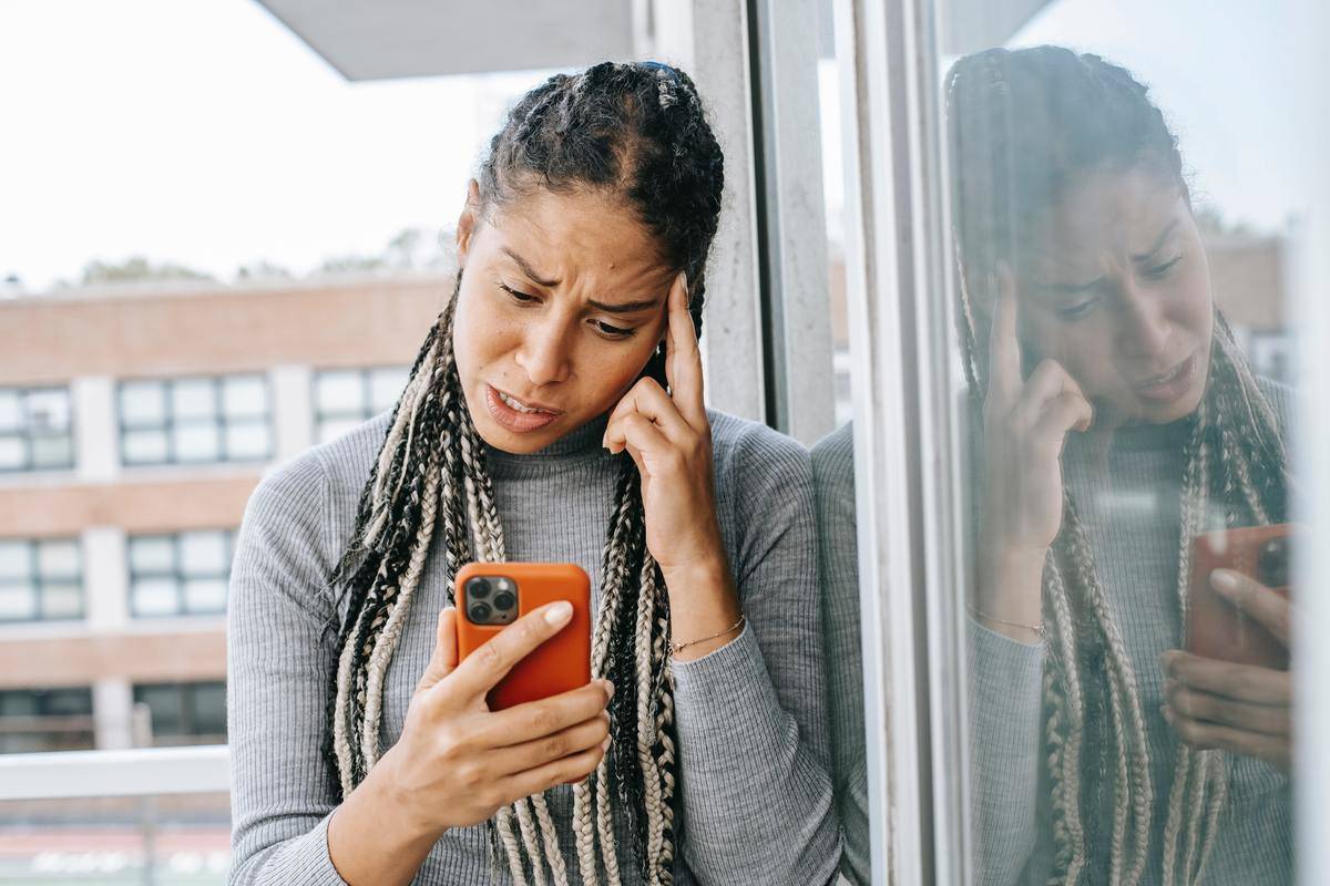 woman outside upset looking at phone