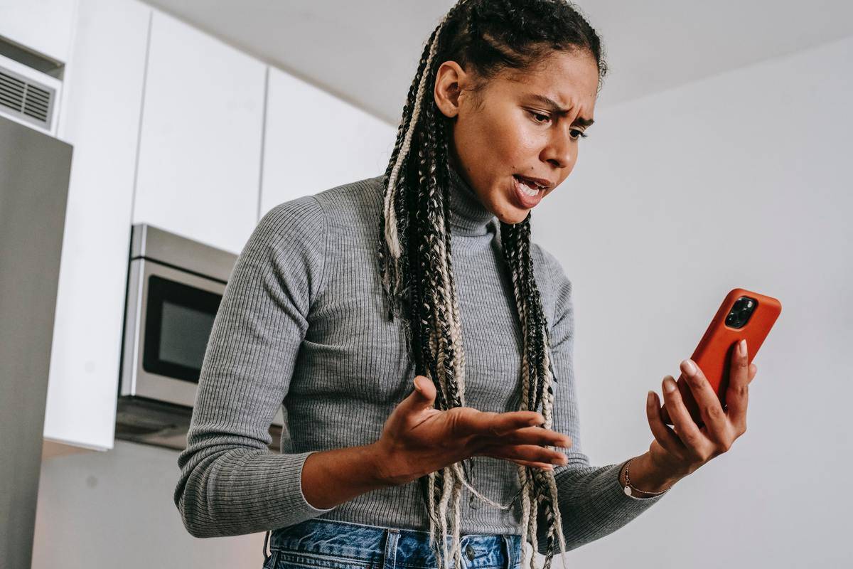 woman looking angry yelling at phone