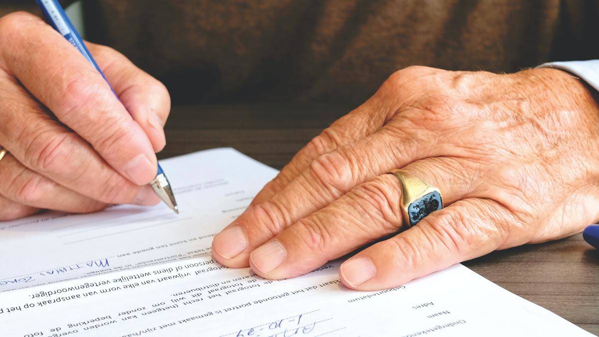 Man signing paperwork