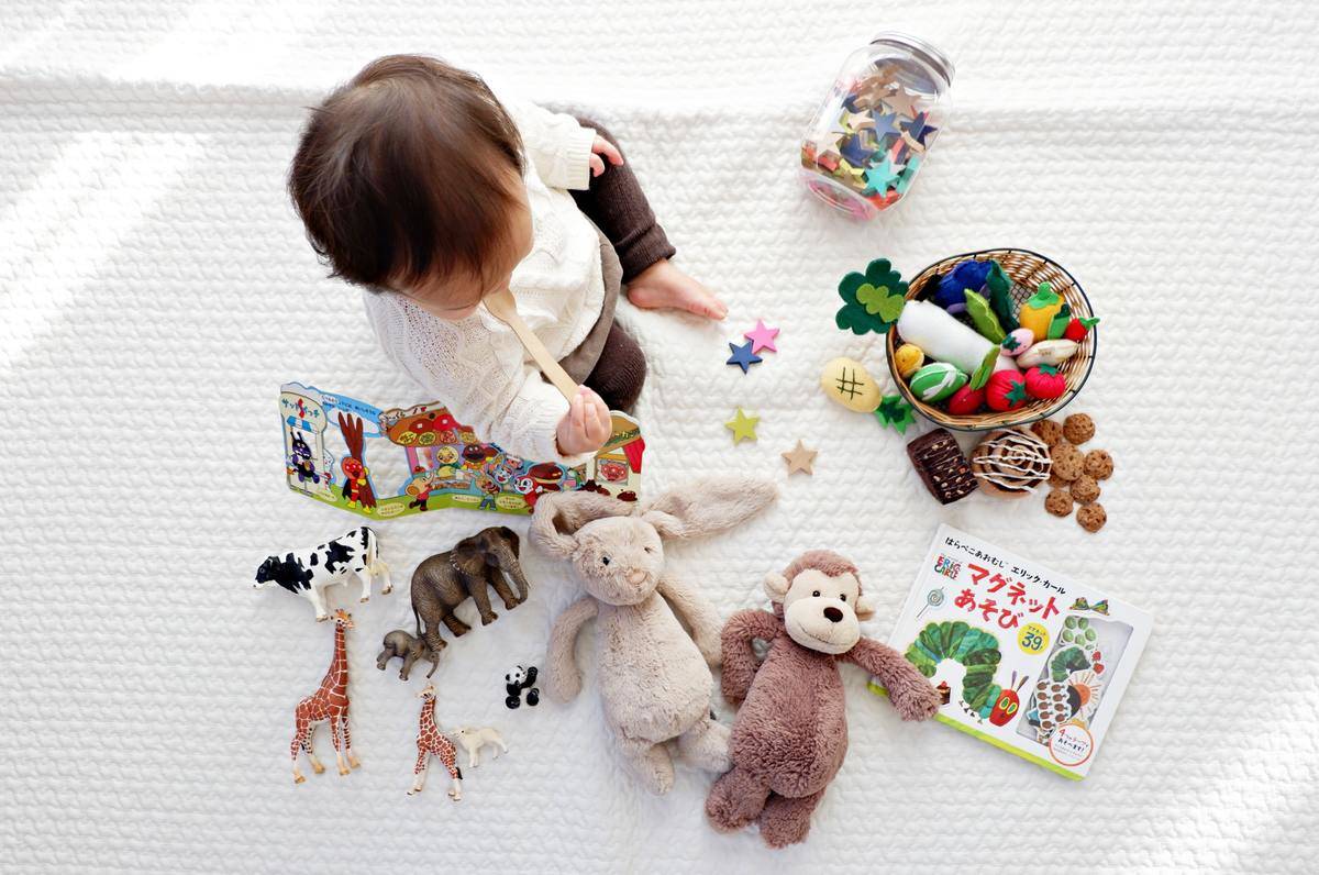 baby playing on the carpet with toys