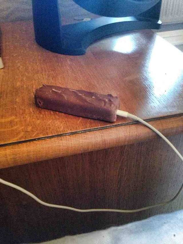 chocolate bar plugged into iphone jack on desk
