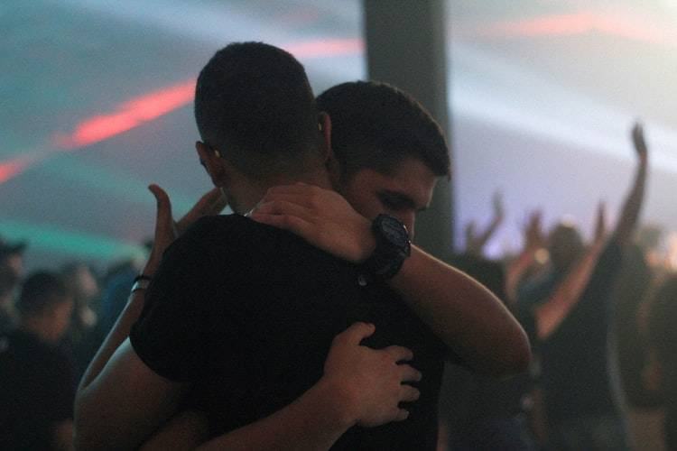 two men embracing on the dance floor