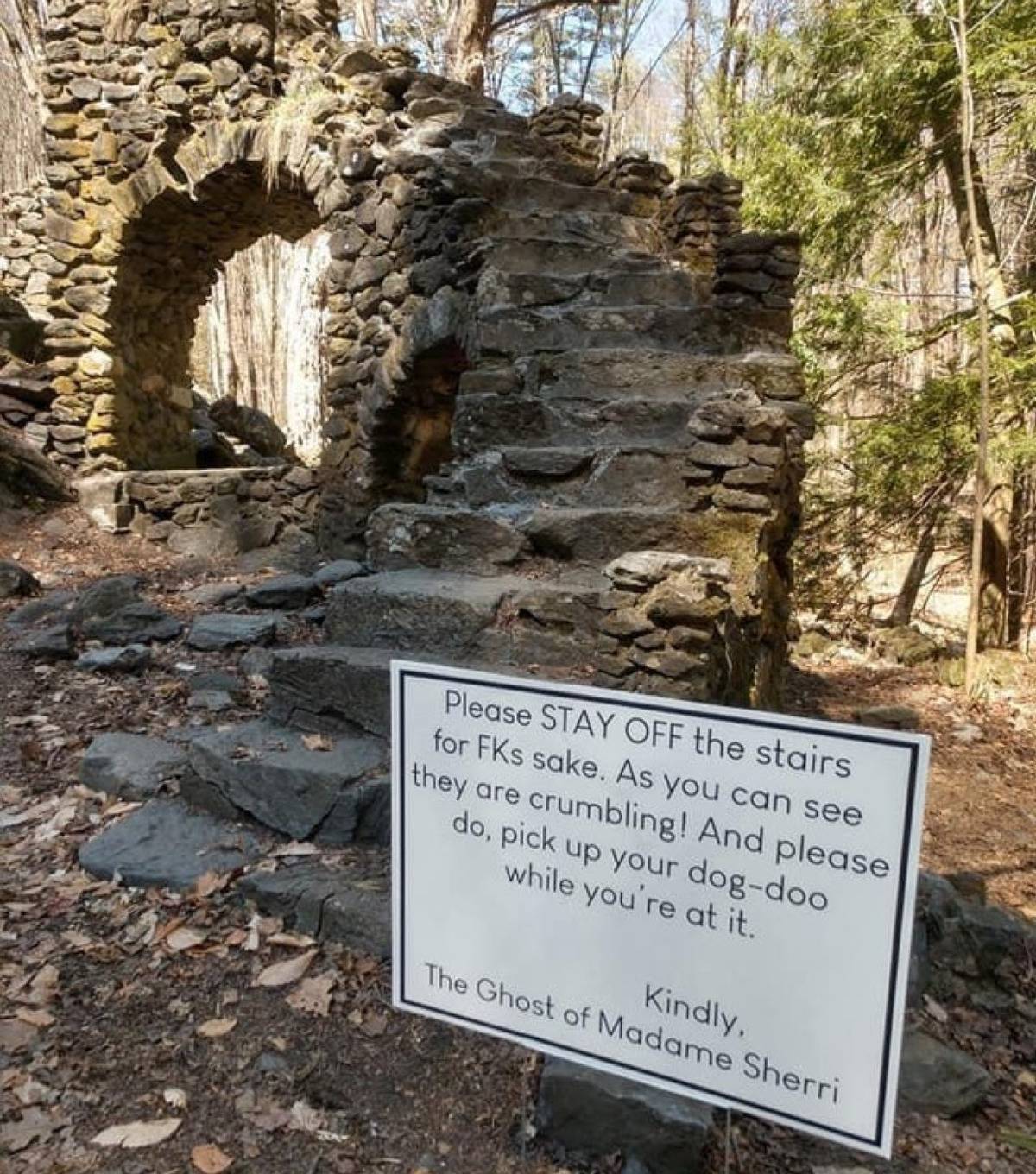 warning sign about going on the stairs signed off by a ghost 