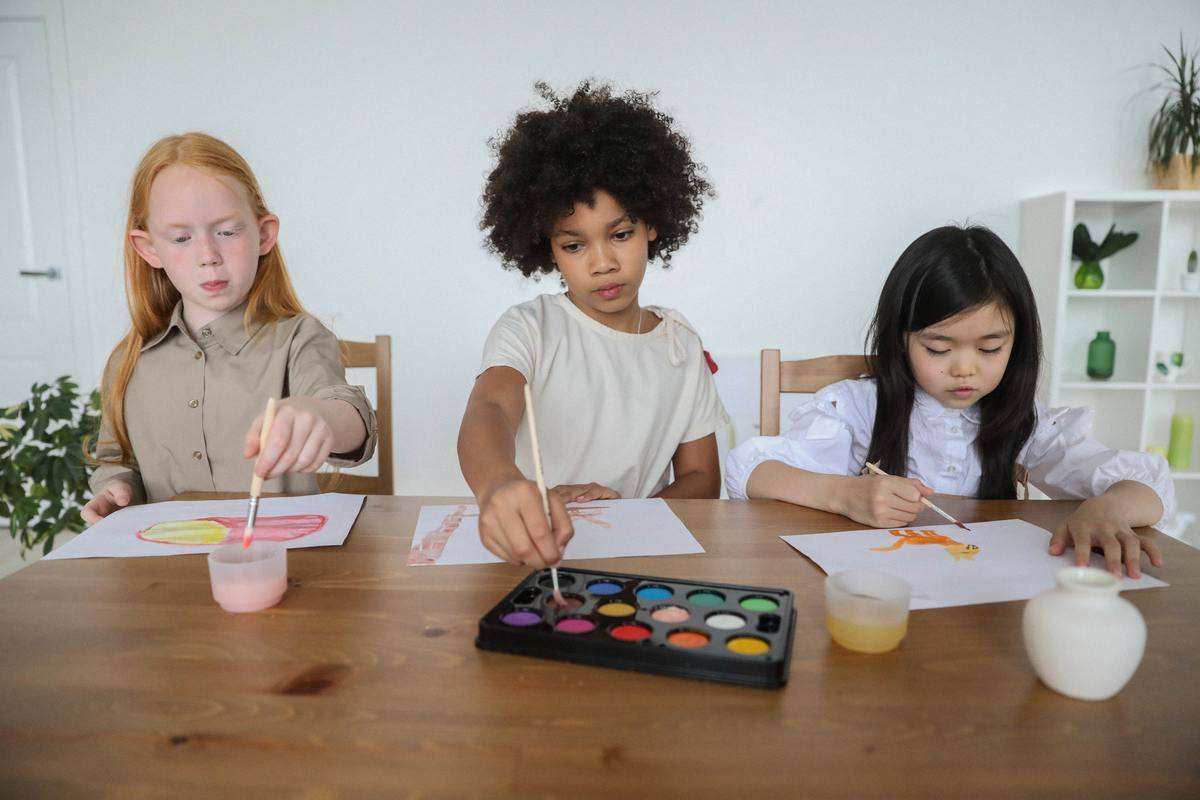 girls sitting painting at table