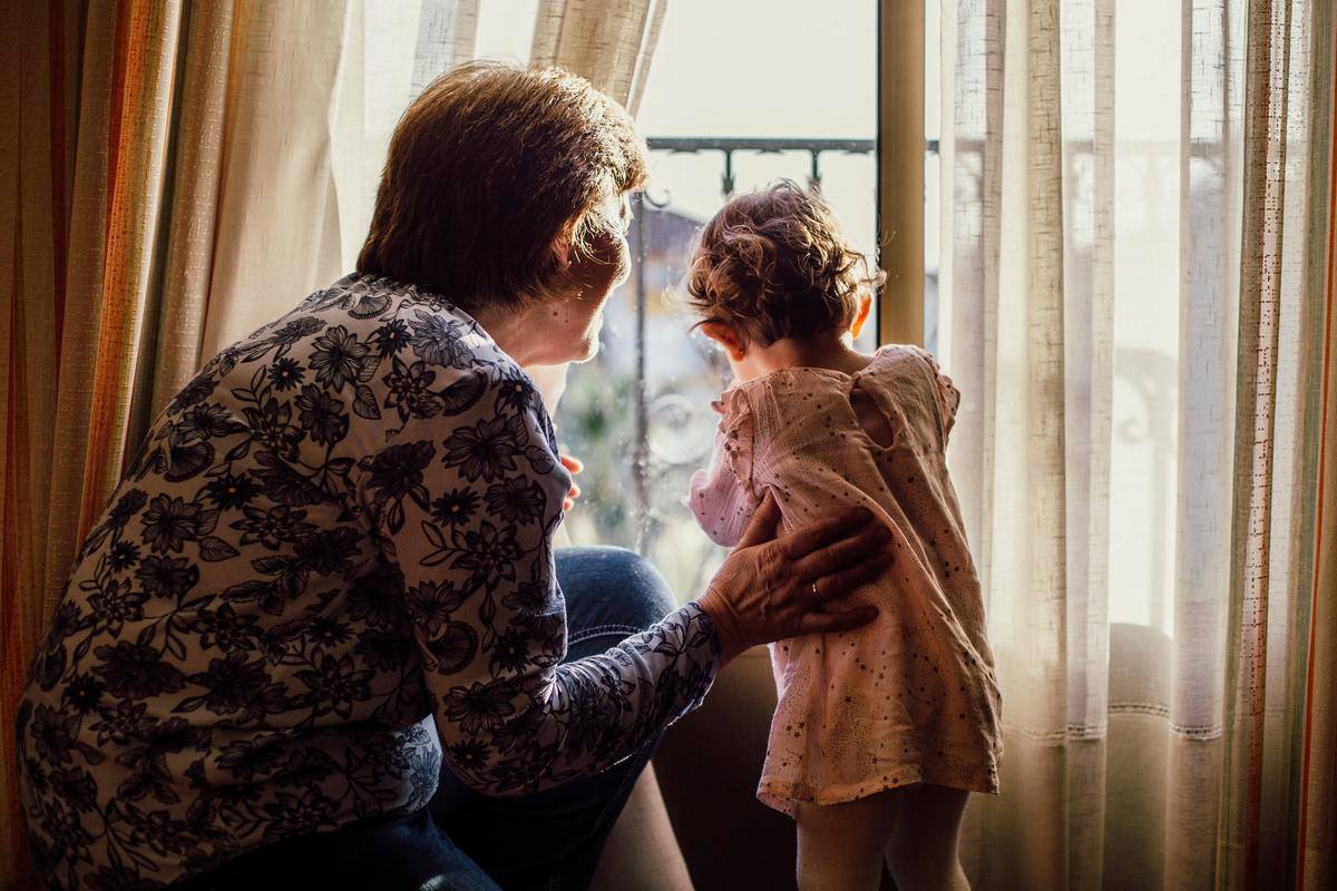 grandma and toddler looking out the window