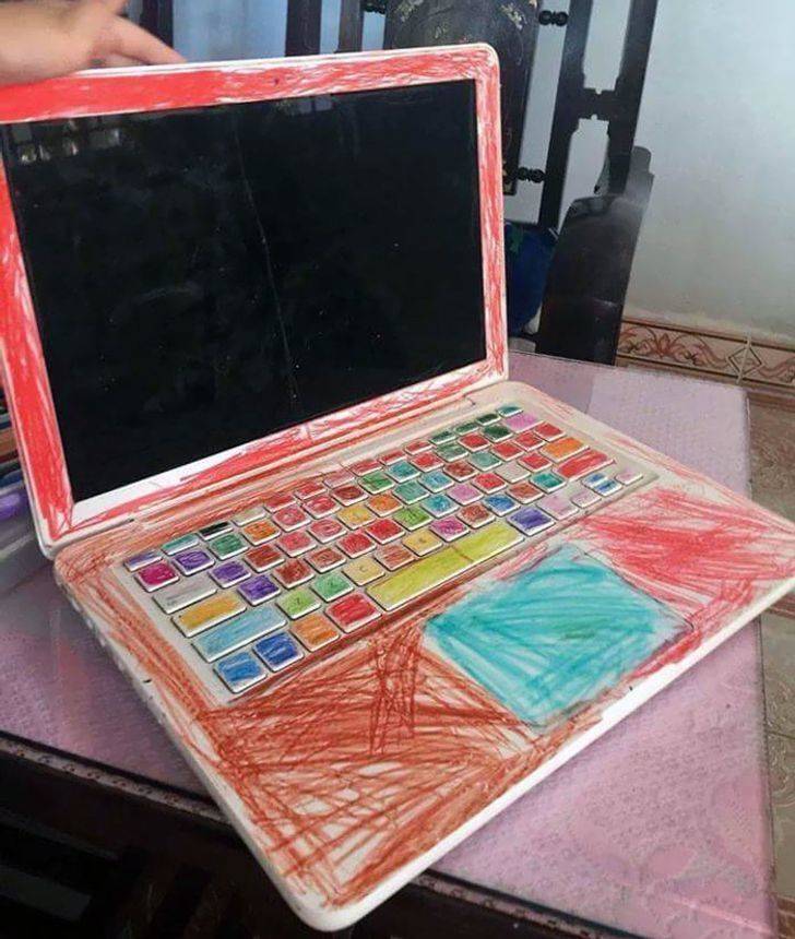mac computer covered in crayons