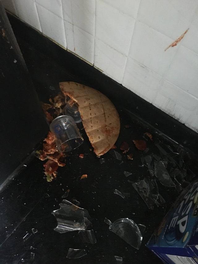 pizza face down in broken glass