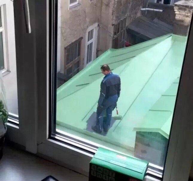 man painting roof stuck in the corner