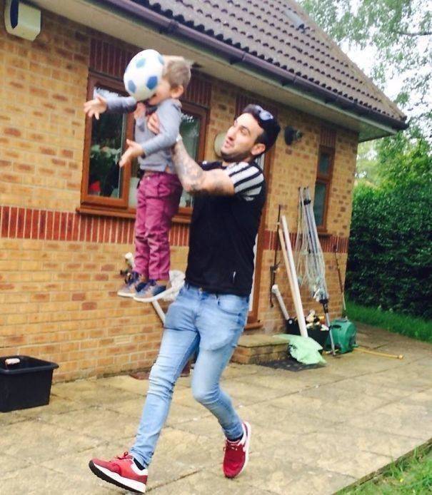 kid held up by dad getting hit by ball