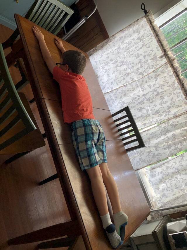 boy lying on table