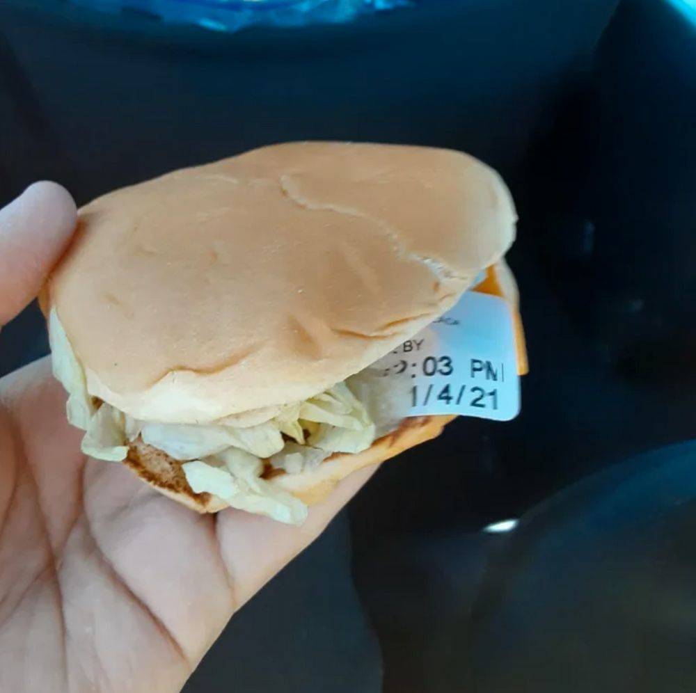 someone found a sticker in their burger