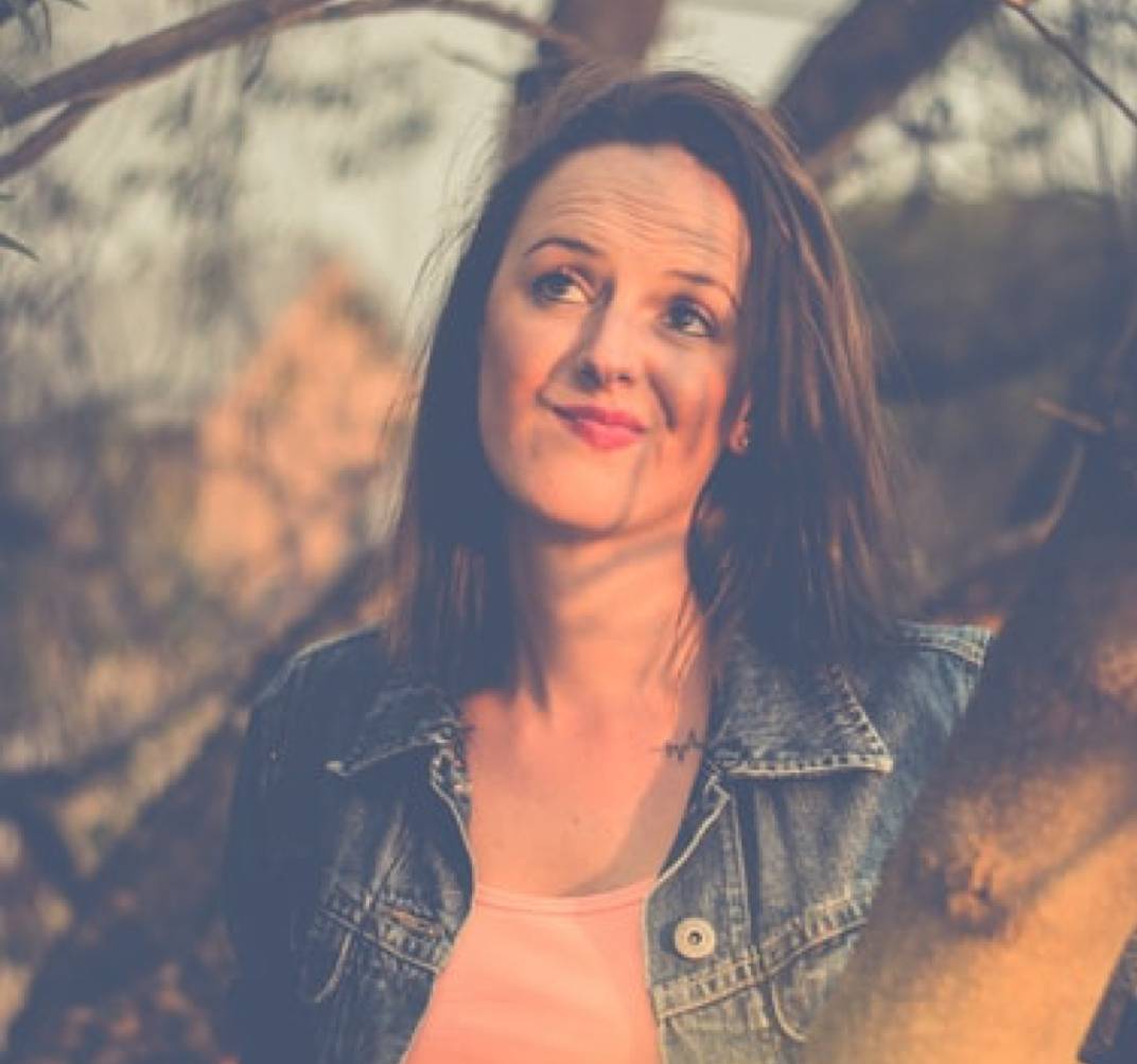 Brunette woman outdoors looking pensive