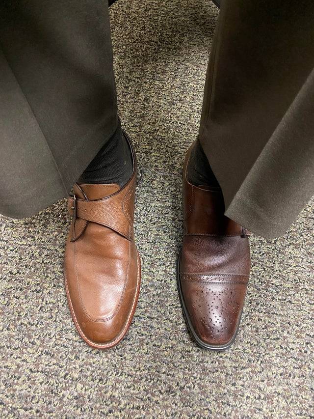 man wearing two different shoes