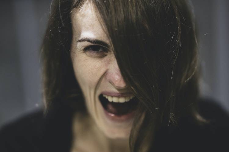 up close image of middle aged woman screaming