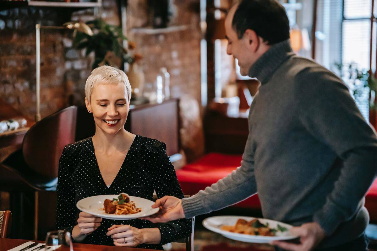 woman served pasta at restaurant