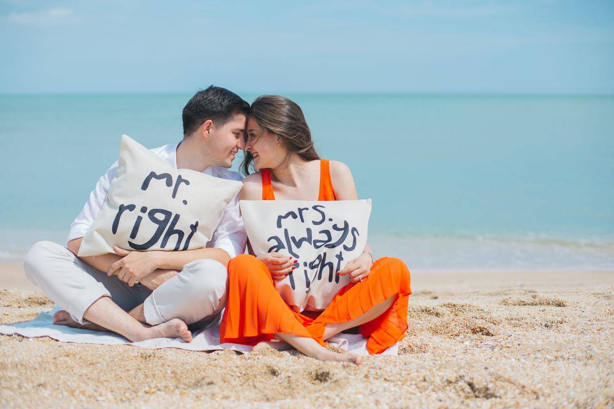 Couple with pillows at beach