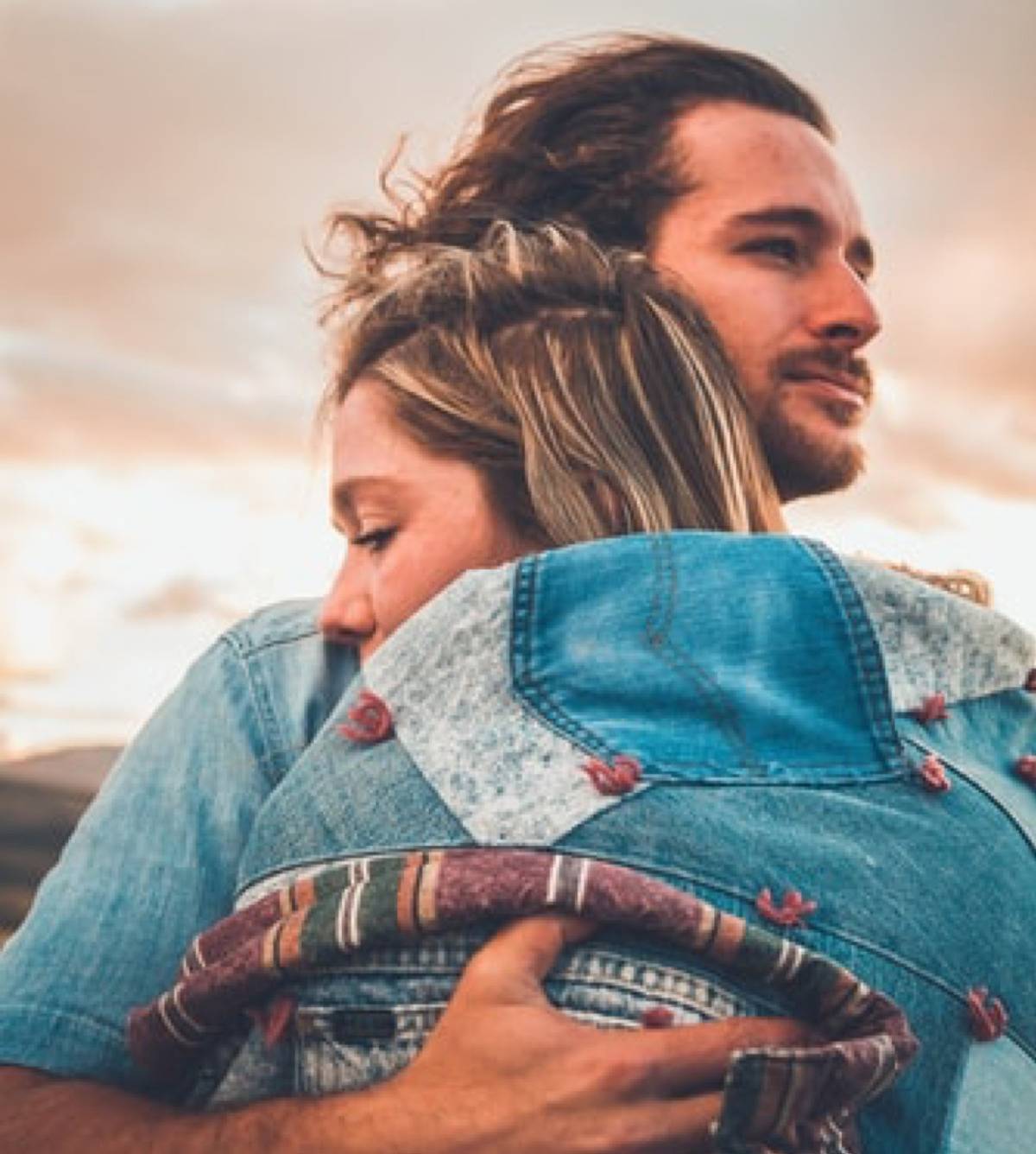 woman hugging man with her eyes closed