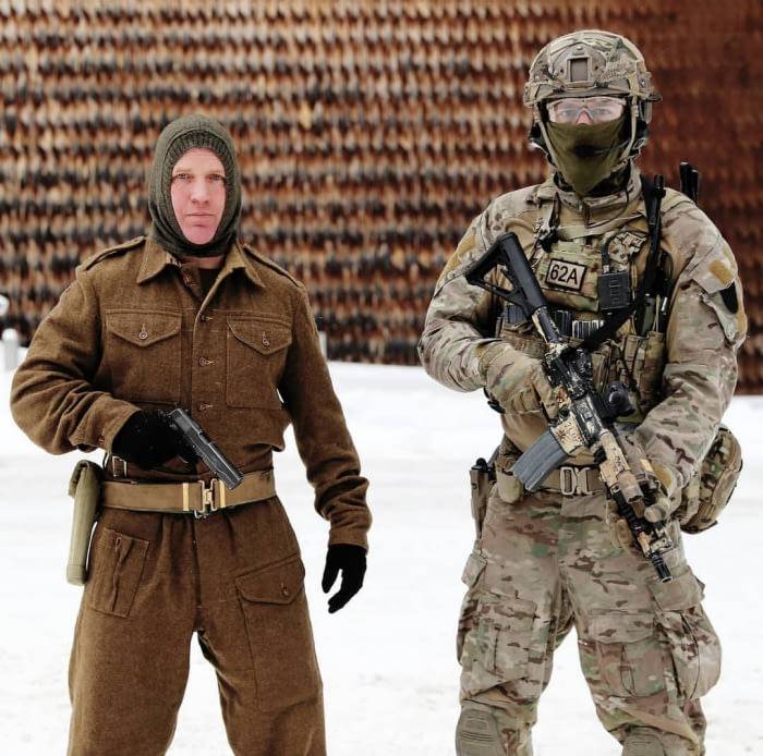 Two Norwegian soldiers stand side by side, one dressed in uniform from 75 years ago, one dressed in modern tactical gear