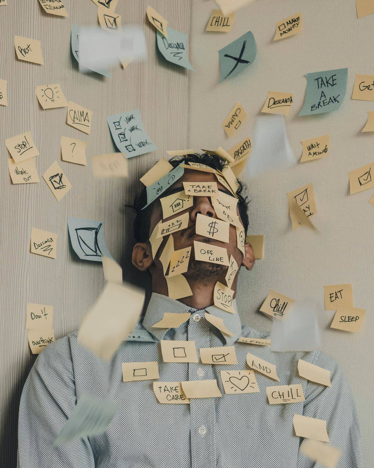 Man is covered with Post-It notes