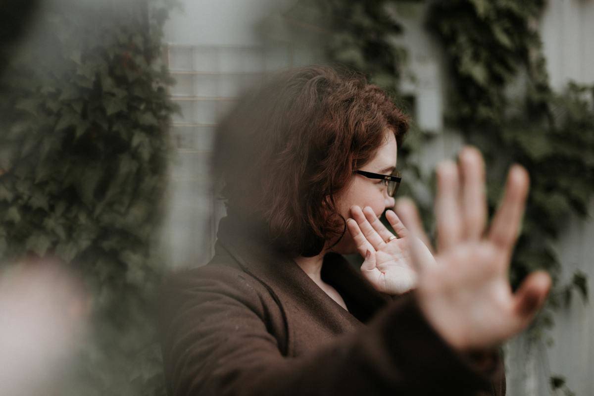 Woman holds up her palm toward the camera