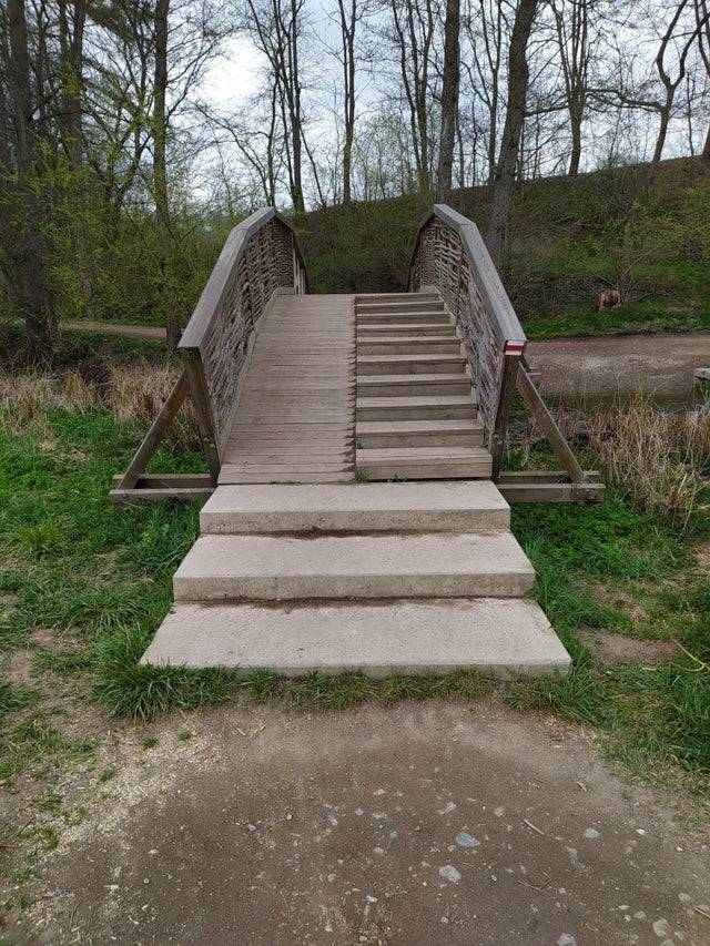 a ramp on a bridge that ends with stairs