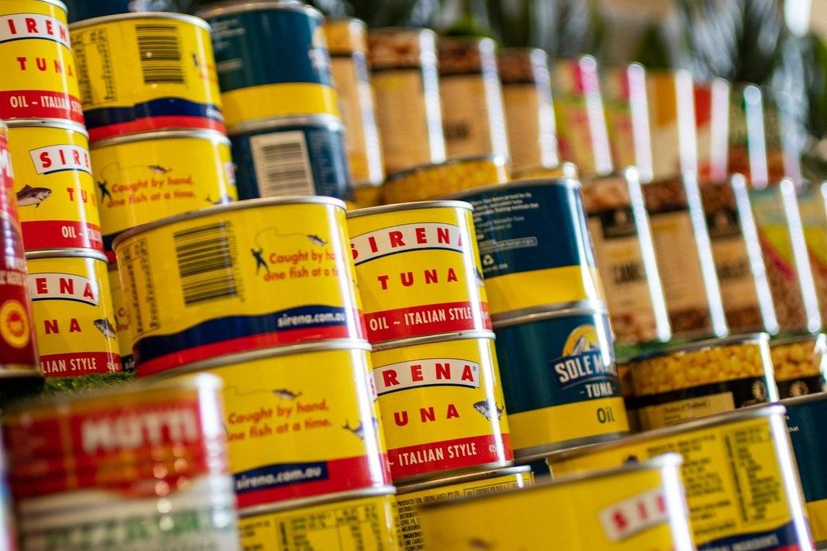 Cans of tuna are stacked on top of each other.