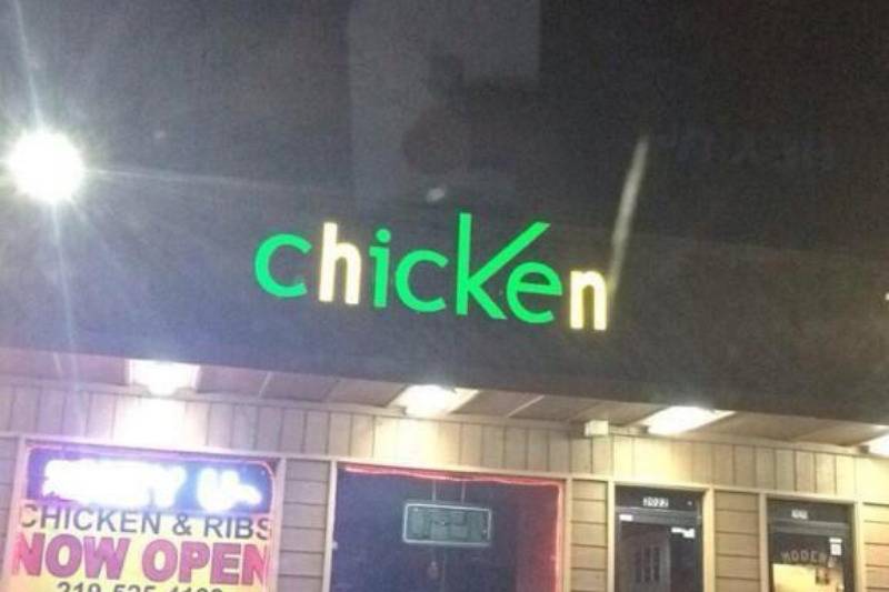 chicken with green letters on sign