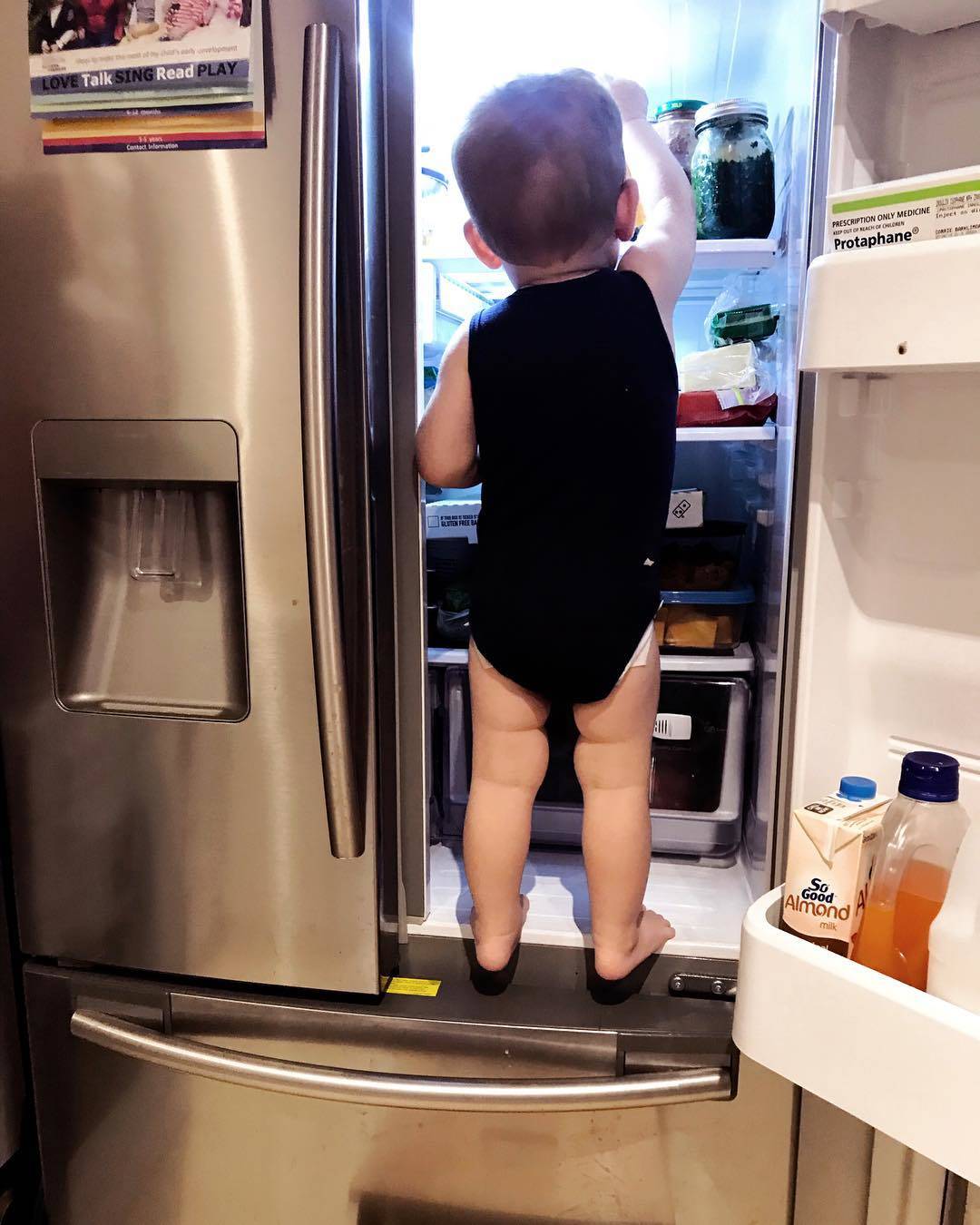 kid climbing in fridge
