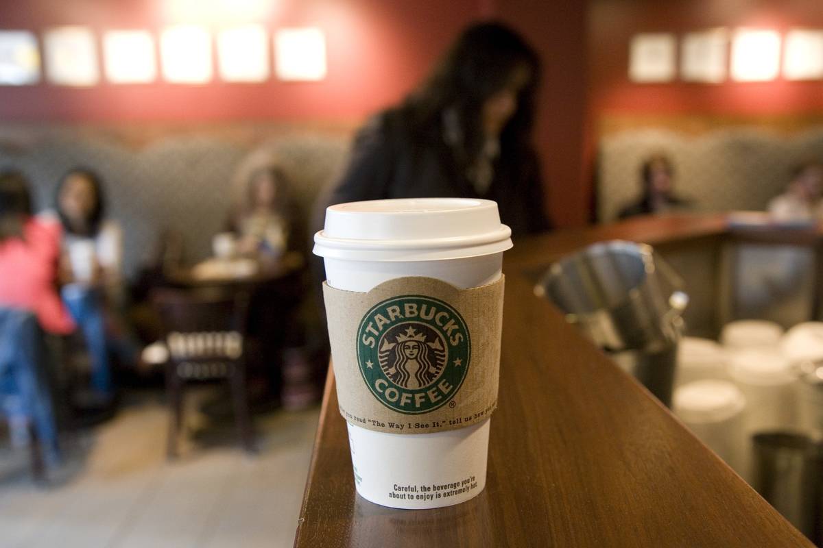 A Starbucks to-go cup has a sleeve to not burn peoples' hands.