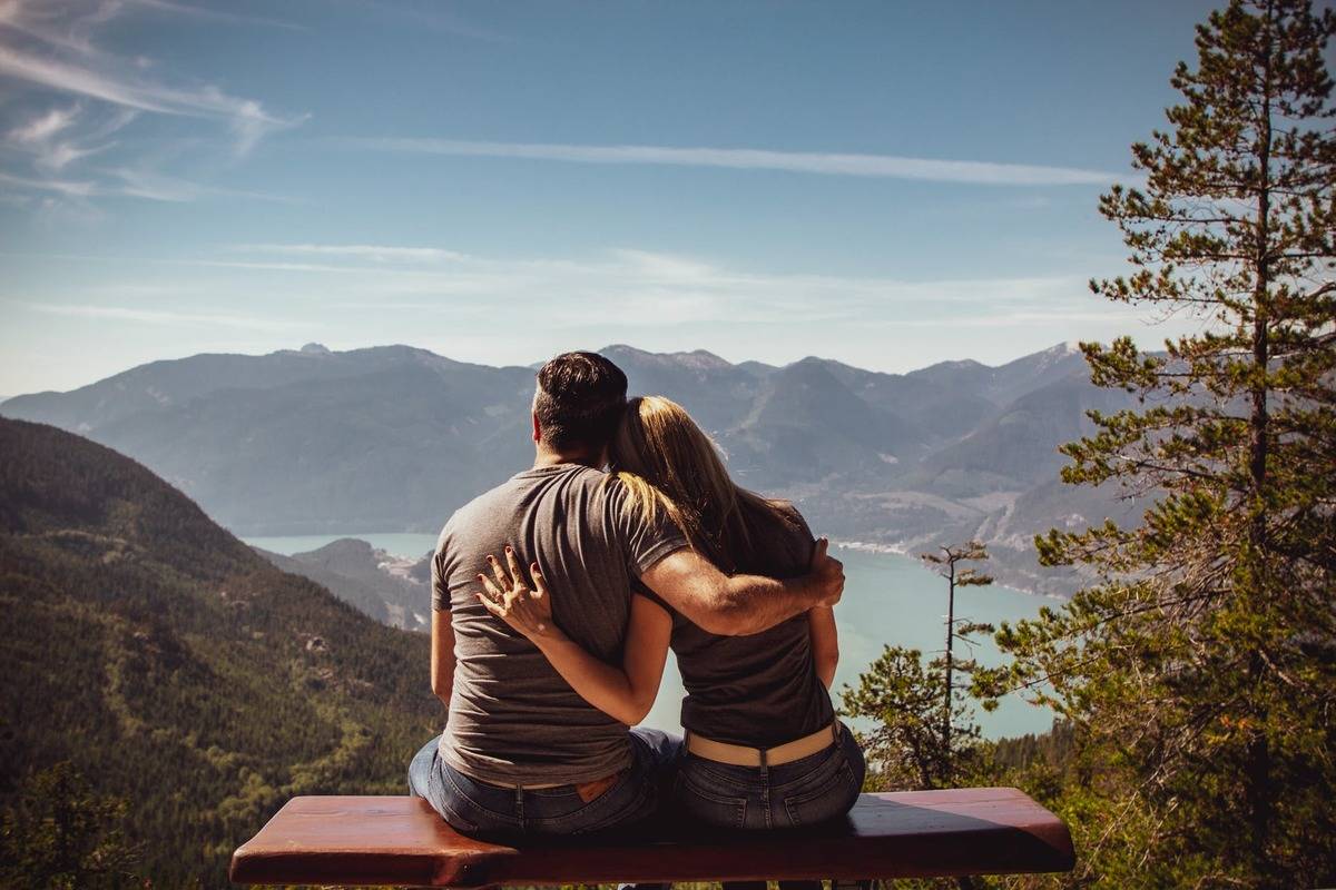 couple holding one another staring out at a beautiful view