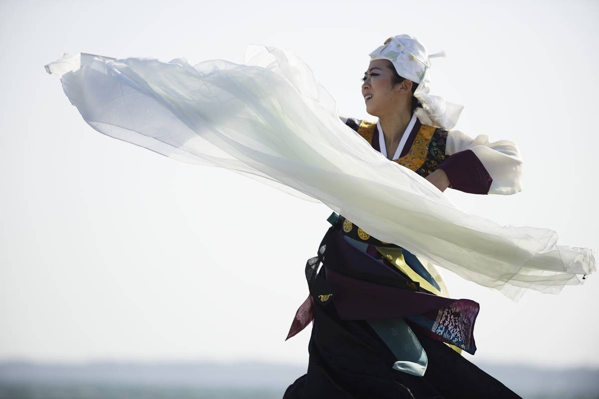 An artist performs a dance on the beach to commemorate the Great East Japan Earthquake on March 11, 2021 in Iwaki,