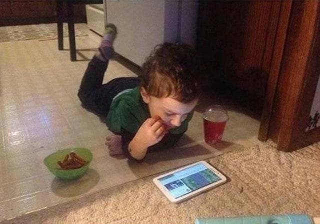 kid using phone on the floor
