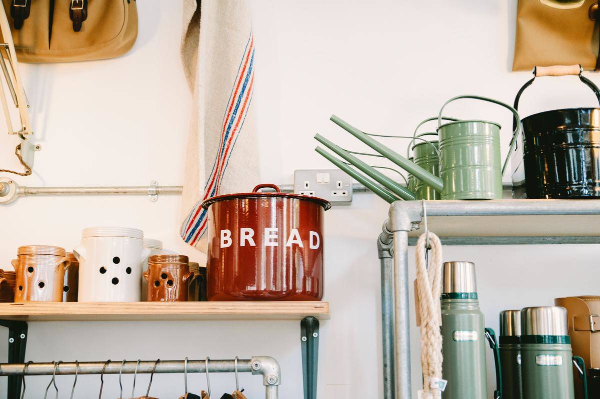 cans and watering cans on shelf