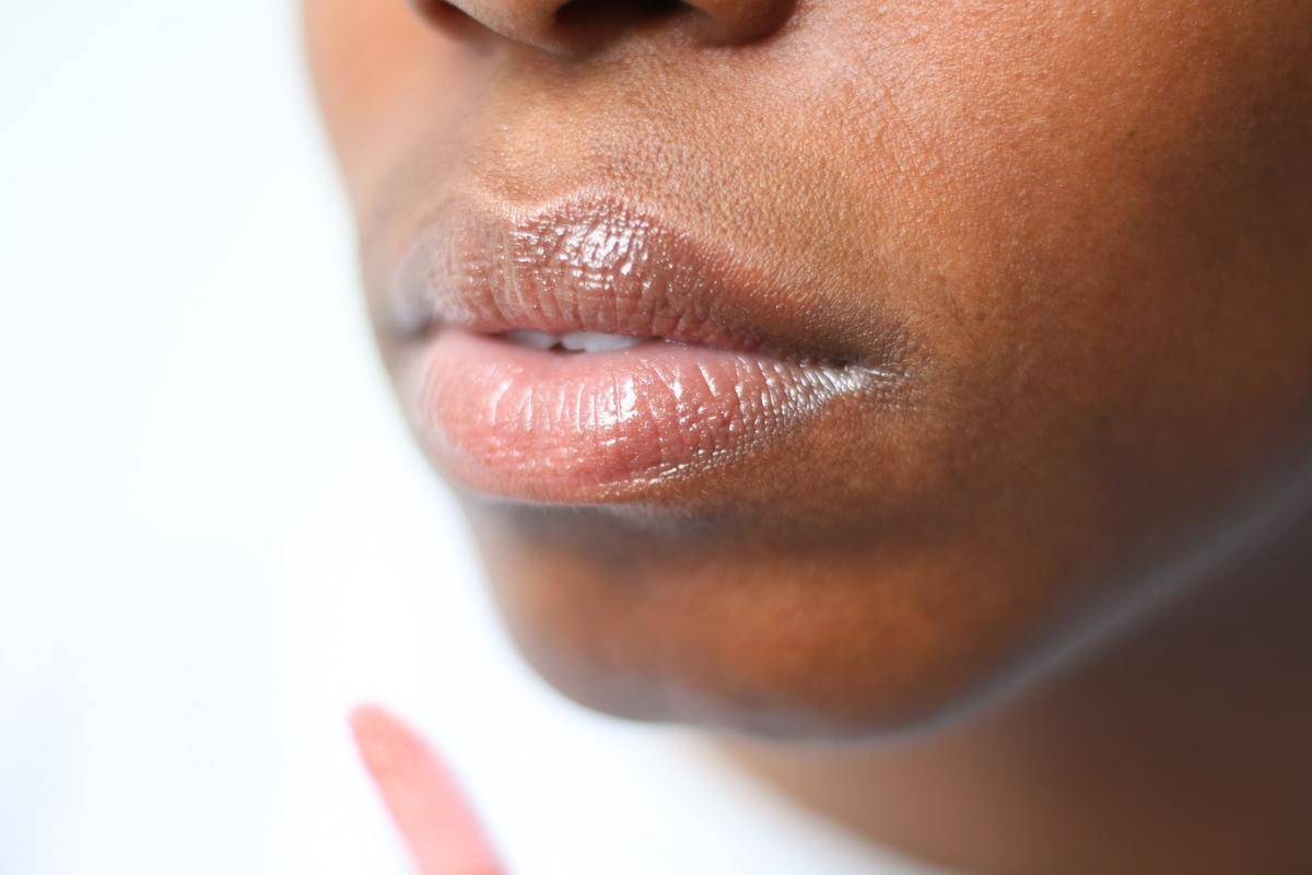 A close-up photograph shows a woman's lips.