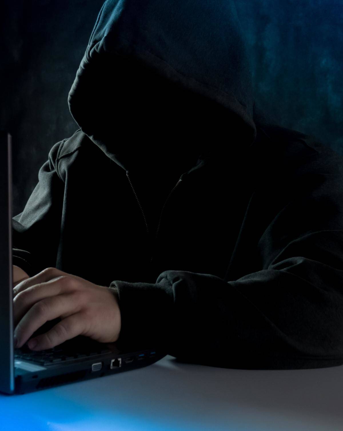 man in hoodie typing