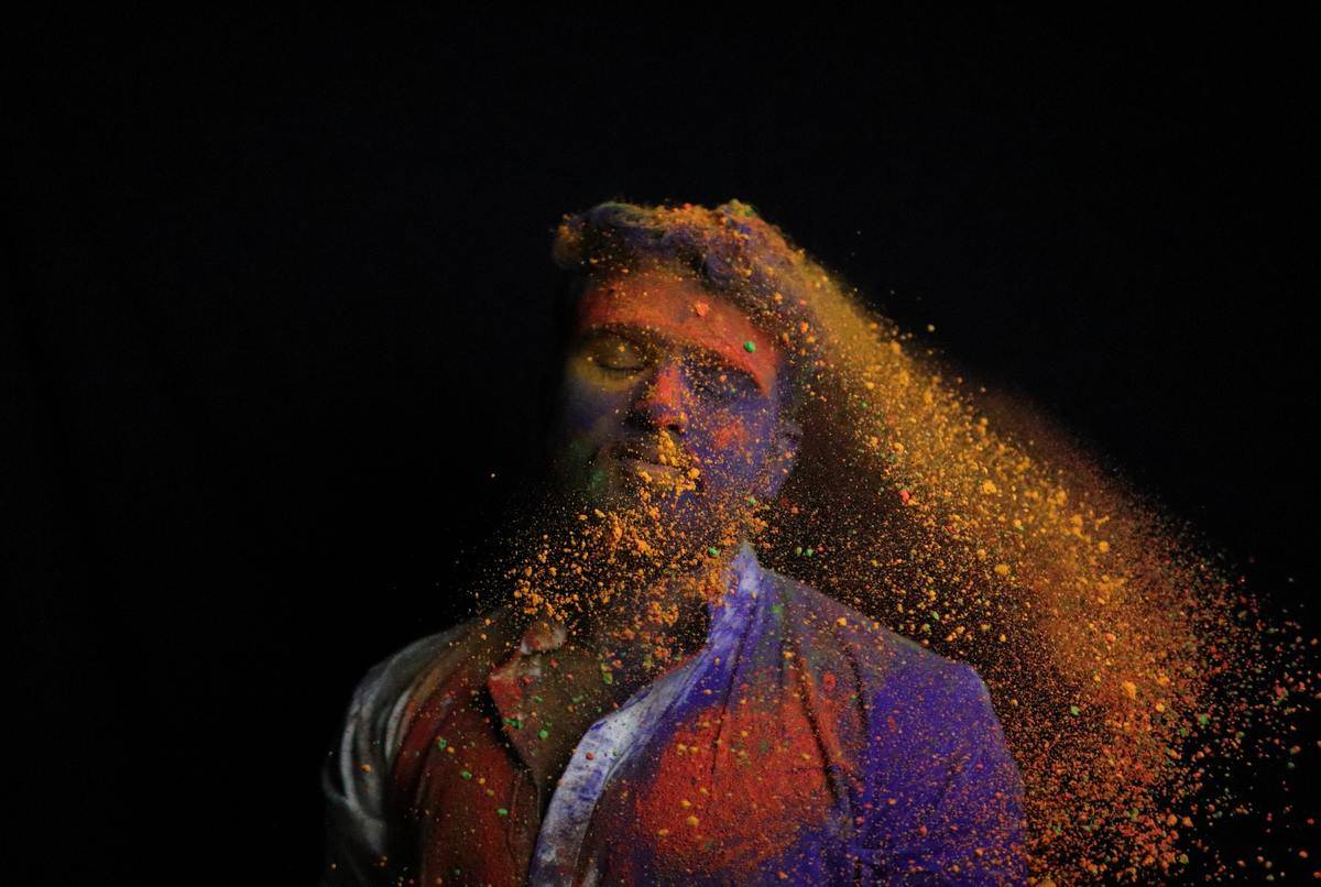 man with paint colors splattering