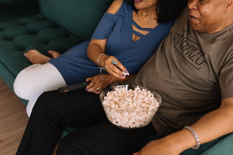 couple eating popcorn on couch